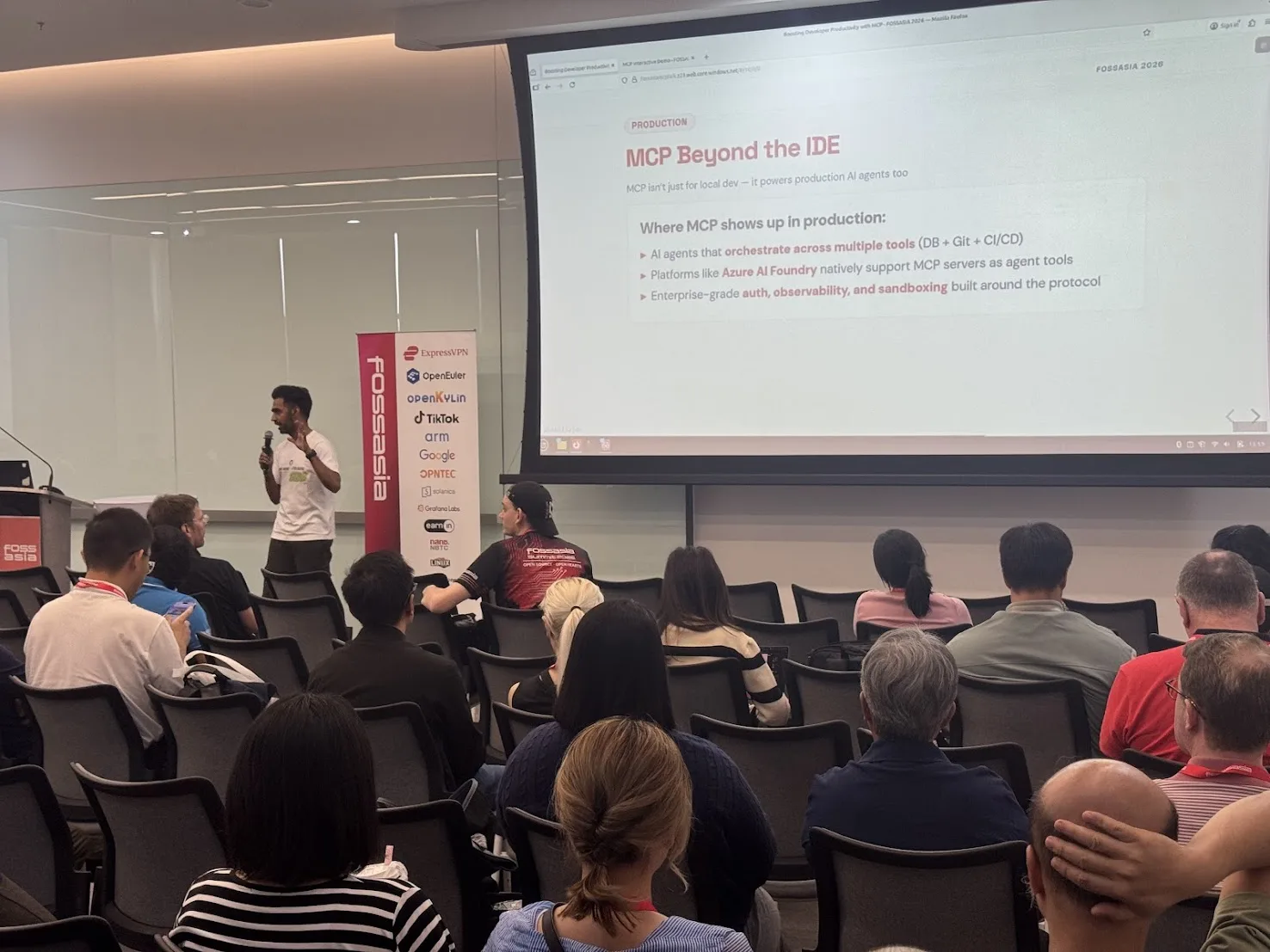 Speaker presenting a session about MCP and AI agents to an audience at the FOSSASIA Summit conference.