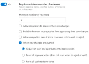 Screenshot from Azure Repos UI showing "Require a minimum number of reviewers" policy that is configured to require at least one approval on the last iteration when new changes are pushed