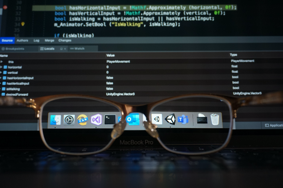 glasses focused on Visual Studio for Mac and Unity on a computer